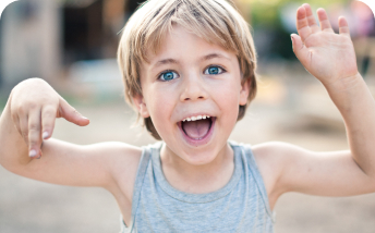 niño rubio de ojos azules corriendo hacia la cámara