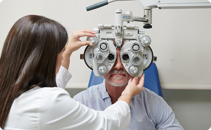 médico y hombre paciente maduro después de una prueba con foróptero