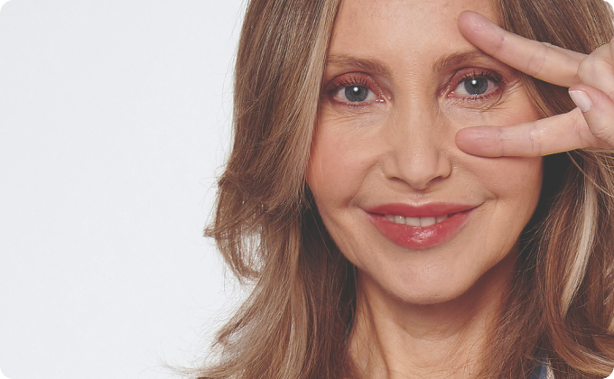 mujer paciente de oculoplastia haciendo la señal de la victoria